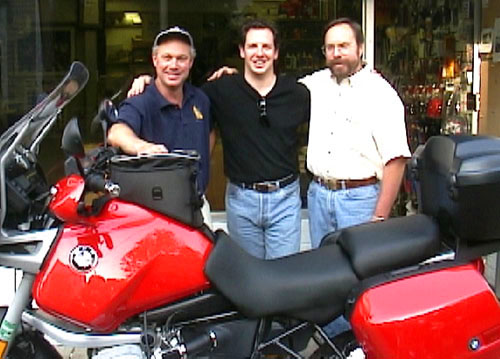 David Dorrance (left) and Art Blight (right) of Lindner Cycle Shop congratulate Dan on his new motorcycle.